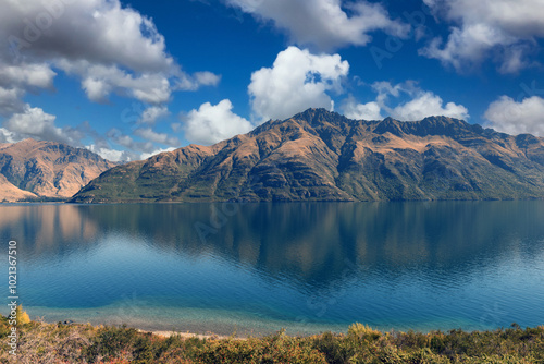 Fototapeta Naklejka Na Ścianę i Meble -  panoramic scenic view of Lake Wakatipu with mountains in the background near Queenstown, South Island, New Zealand
