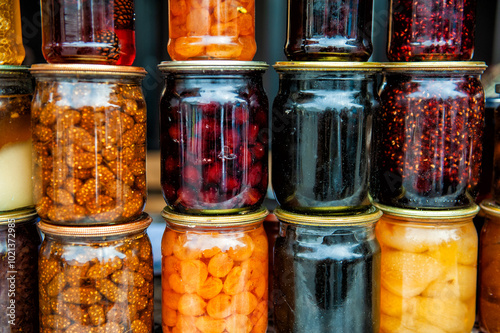 Homemade fruit preserves neatly arranged in glass jars, showcasing rustic and organic food photo