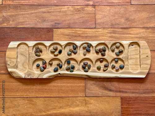 Handcrafted Wooden Mancala board with Colorful Stone Seeds - A boardgame of Arab, Muslim, African, and Asian Heritage Spread Through Migration