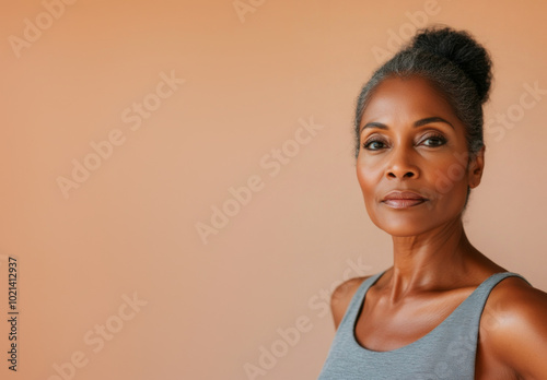 Portrait of confident mature African American woman, neutral background with copy space