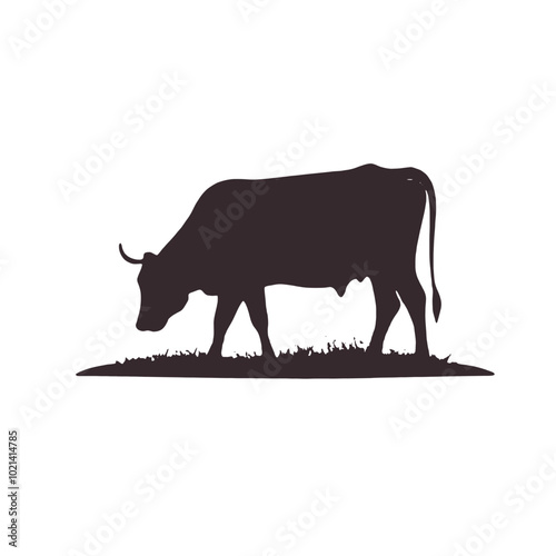 A black silhouette of a cow grazing in a grassy field