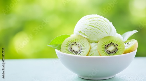 Bowl of lime ice cream with kiwi slices, served outdoors in the garden photo