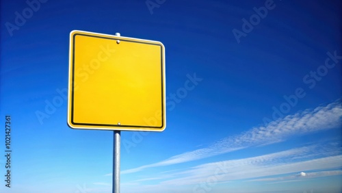 Blank Yellow Road Sign Against A Bright Blue Sky With White Clouds