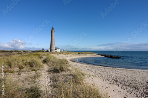Fototapeta Naklejka Na Ścianę i Meble -  View to Grenen beach with lighthouse and sand dunes by the Baltic Sea in Skagen, Denmark.	