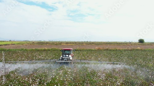 Aerial View of Tractor Spraying Defoliant on Cotton Field