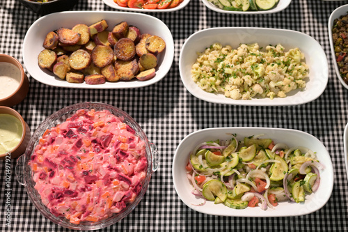 healthy food dish with salad greens vegetables seasoned salad vegan lunch tomato and onion green zucchini