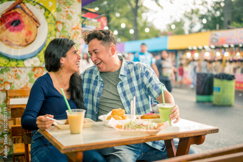 Friends share food, talk and laugh with great joy.