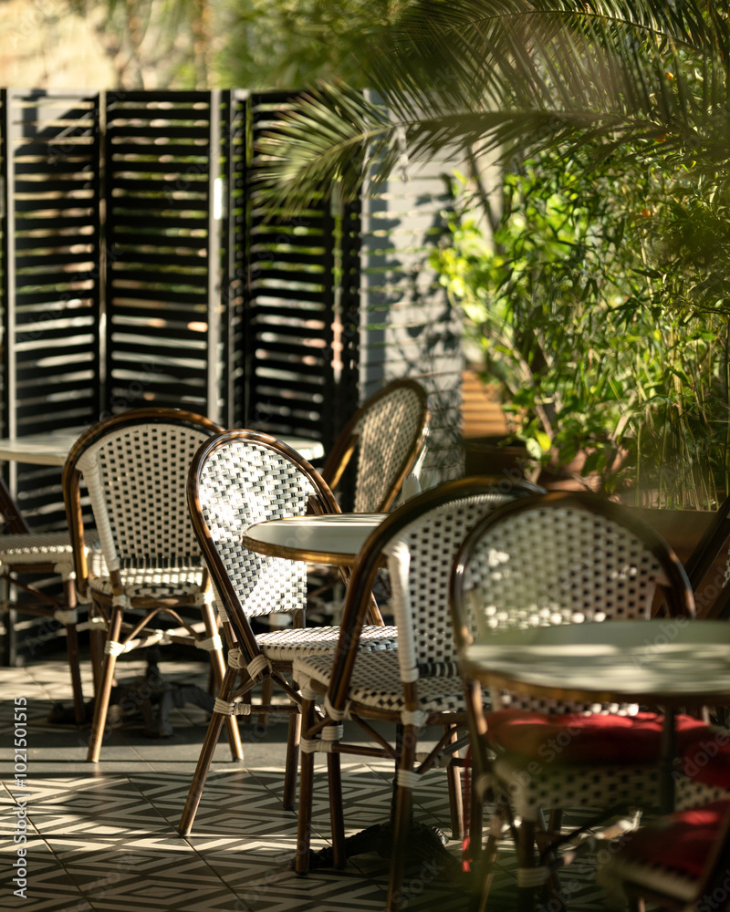 Obraz premium Restaurant, cafe for events, dining with chairs and tables. Atmospheric Italian, Spanish terrace with greenery. Sunny Portuguese place to relax. Restaurant at hotel. Lots of plants in establishment
