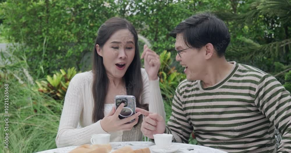 Couple Asian looking mobile and very happy Couple Asian looking mobile and very happy
