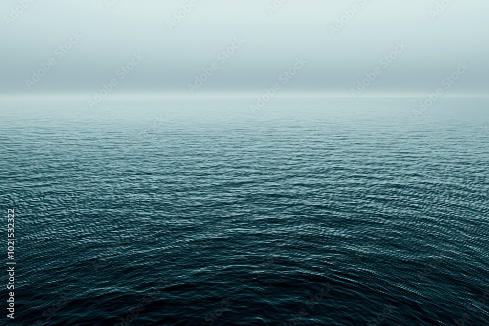 Obraz premium A Calm Sea with a Foggy Horizon