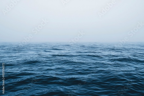 Calm Ocean Water Under Foggy Sky