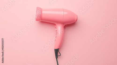 Pink hair dryer on a pastel pink background top view