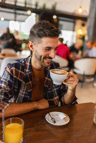 Handsome man drinking coffee in a restaurant.