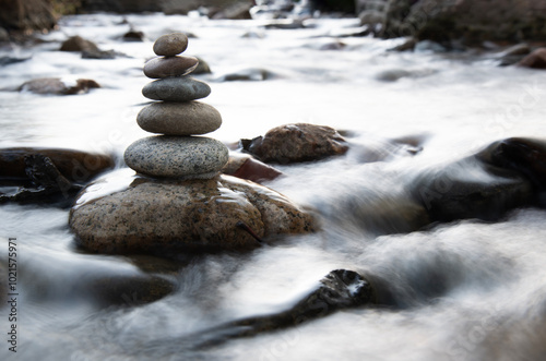 balanced stones on stream photo