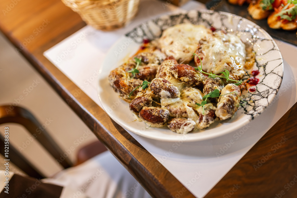 Tasty meat in creamy sauce with mashed potatoes and vegetables. Food and drink concept. Tasty meat in creamy sauce with mashed potatoes and vegetables. Food and drink concept.
