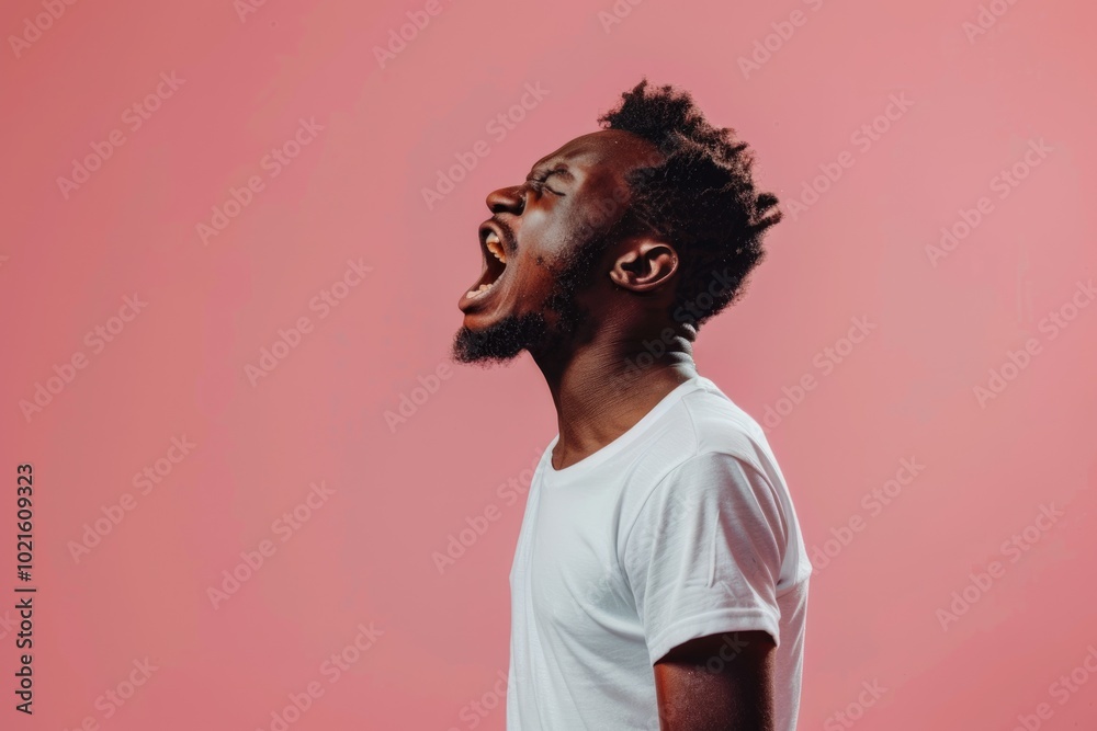 Unhappy African man jumping with anger on pink background. Unhappy African man jumping with anger on pink background.
