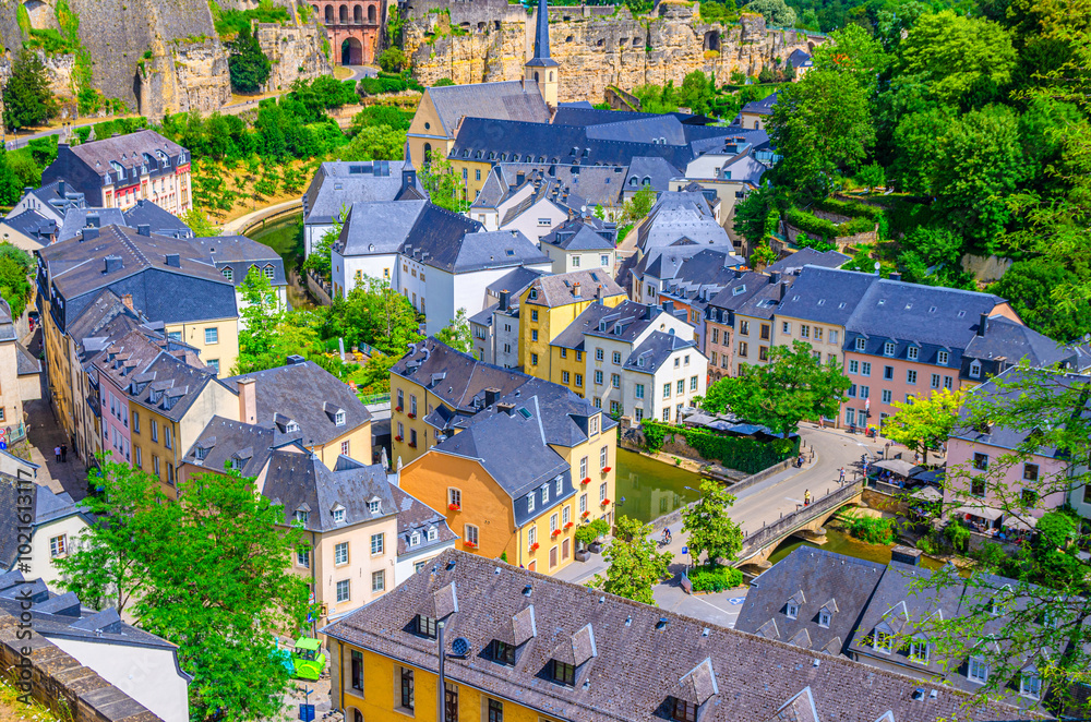 Fototapeta premium Luxembourg City historical centre aerial view with old colorful buildings on narrow streets, Pont du Grund bridge across Alzette river, top view of Luxembourg old town Grund district