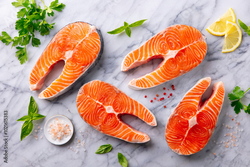 Salmon steaks, fillet with herbs and spices. White marble background. Top view. photo