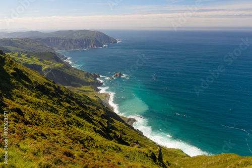 green mountains under blue sky over ocean coast, beautiful nature landscape