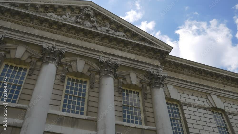 A low angle view of a classical building with columns and sculptures. A low angle view of a classical building with columns and sculptures.