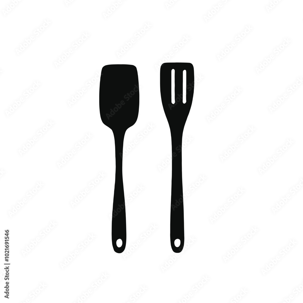 Two black kitchen utensils, a spatula and a slotted spoon, on a white background Two black kitchen utensils, a spatula and a slotted spoon, on a white background