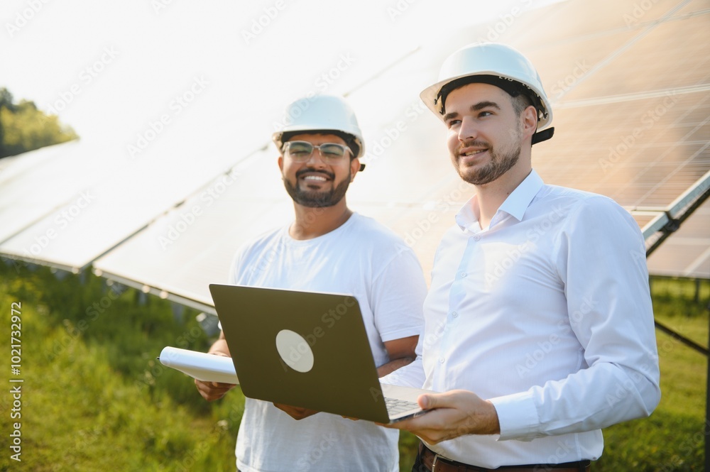 Indian engineer and businessman planing new ecology project. around solar panel Indian engineer and businessman planing new ecology project. around solar panel