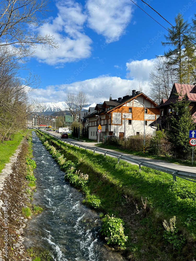 Mountain Village with River Stream and Snowy Peaks Mountain Village with River Stream and Snowy Peaks
