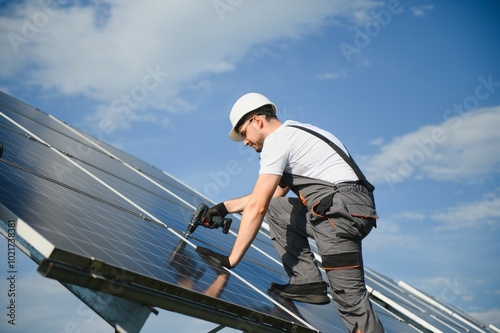 Worker installing solar panels outdoors