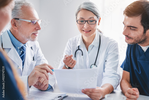 Multiethnic medical staff discussing medical reports in boardroom clinic photo