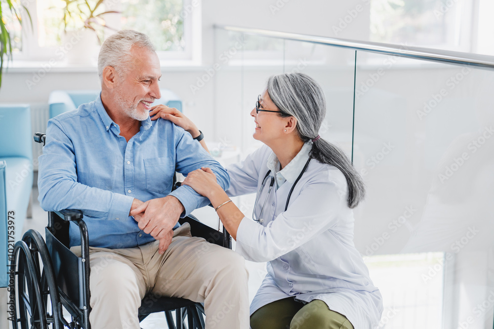 Smiling female doctor physiotherapist taking care of happy senior patient in wheelchair Smiling female doctor physiotherapist taking care of happy senior patient in wheelchair
