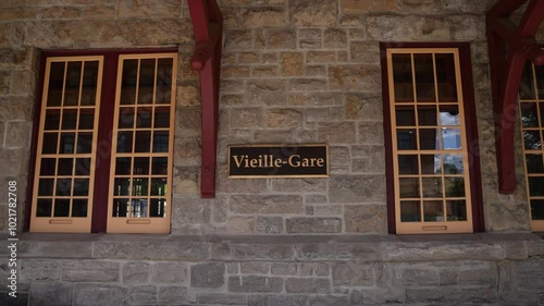Slow motion panning captures the exterior of the historic saint jerome train station in quebec, showcasing its architectural beauty. Selective focus
