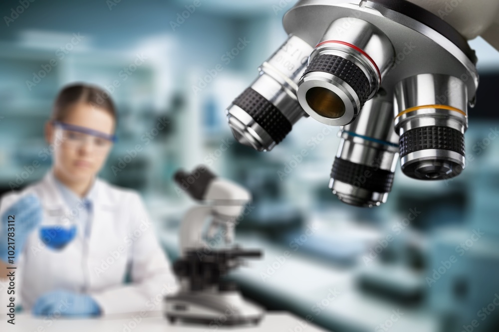 Double exposure of microscope and scientist using equipment .