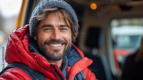 happy truck driver beams while confidently steering the wheel open road behind him sunlight streaming through the windshield capturing a sense of freedom and adventure on the journey photo