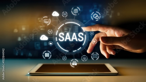 A hand interacting with a digital tablet, showcasing SaaS (Software as a Service) symbols and icons, representing modern technology and cloud computing concepts.