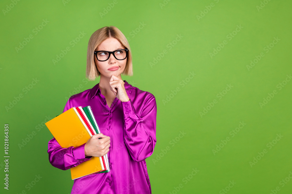 Photo of smart intelligent lovely girl wear stylish pink clothes study college look empty space isolated on green color background Photo of smart intelligent lovely girl wear stylish pink clothes study college look empty space isolated on green color background