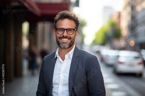 Portrait of a handsome businessman with glasses in an urban setting.