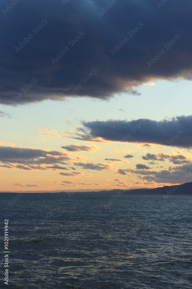 Sunset at sea. Balearic Sea, Salou, Spain. Beach, sea, small waves. Evening landscape on the coast. Vacation at sea Sunset at sea. Balearic Sea, Salou, Spain. Beach, sea, small waves. Evening landscape on the coast. Vacation at sea