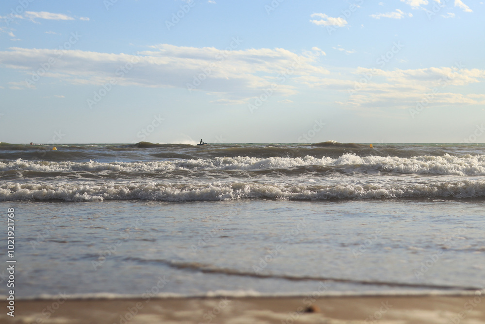Sea view from the shore. Horizon on the sea. Balearic Sea, Salou, Spain. View of the waves on the sea with small waves from a low angle. Landscape Sea view from the shore. Horizon on the sea. Balearic Sea, Salou, Spain. View of the waves on the sea with small waves from a low angle. Landscape