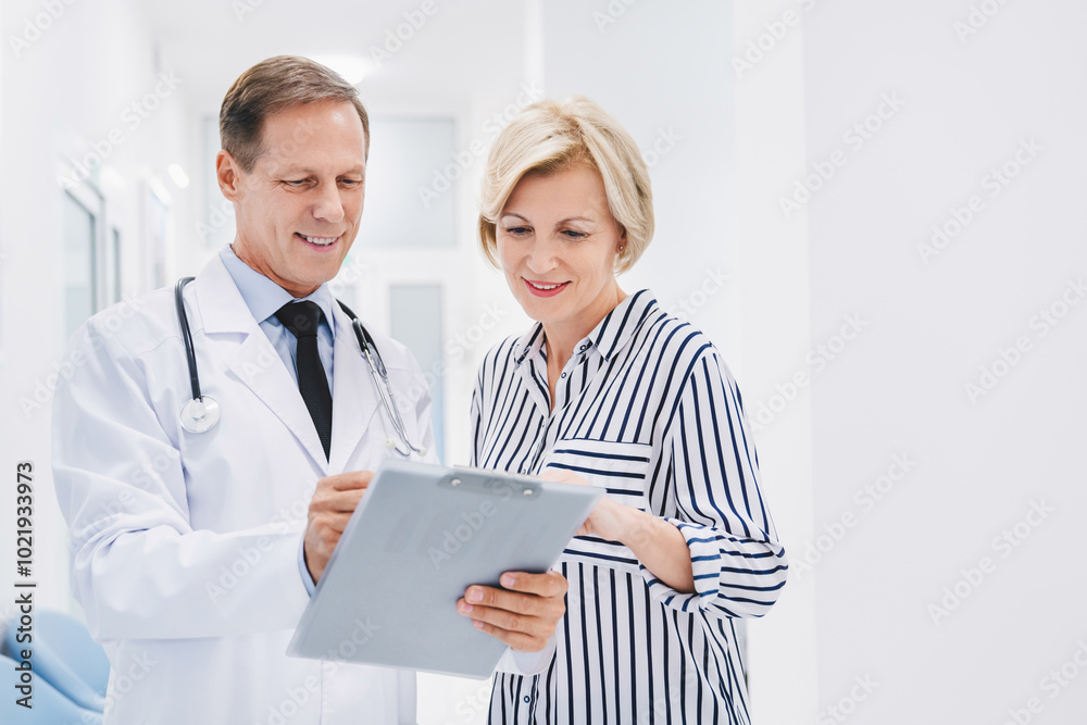 Doctor consulting patient in hospital hallway Doctor consulting patient in hospital hallway