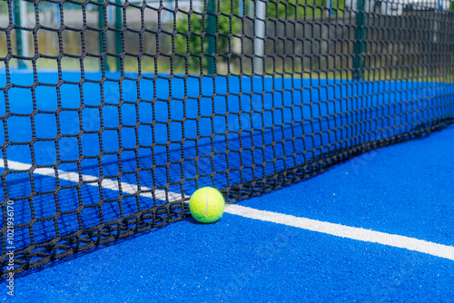 ball at the lower part of the net on a paddle tennis court