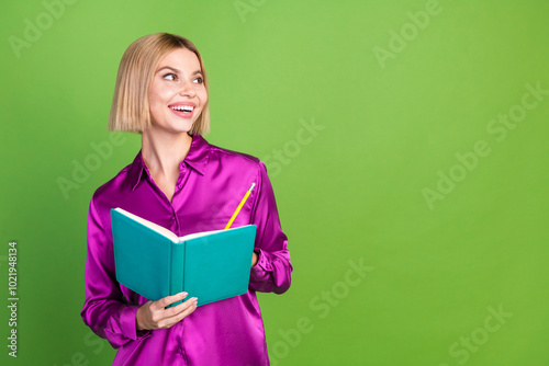 Photo of pretty cute lovely girl wear trendy pink clothes hold book look empty space isolated on green color background