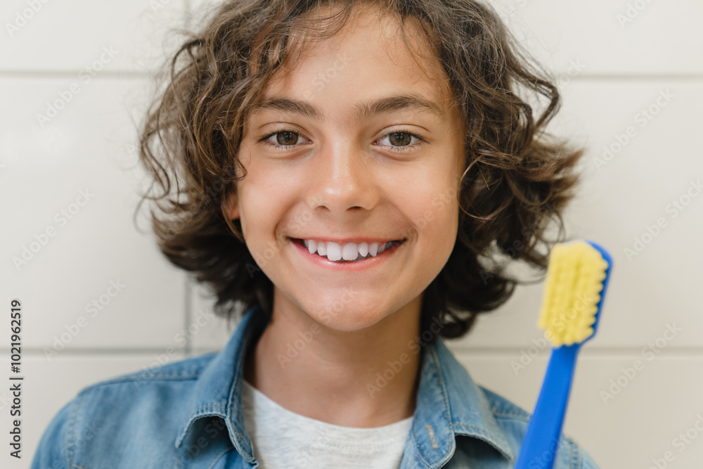 Close up shot of daily routine. Caucasian preteen boy smiling showing teaching learning how to use tooth brush correctly in home bathroom Close up shot of daily routine. Caucasian preteen boy smiling showing teaching learning how to use tooth brush correctly in home bathroom