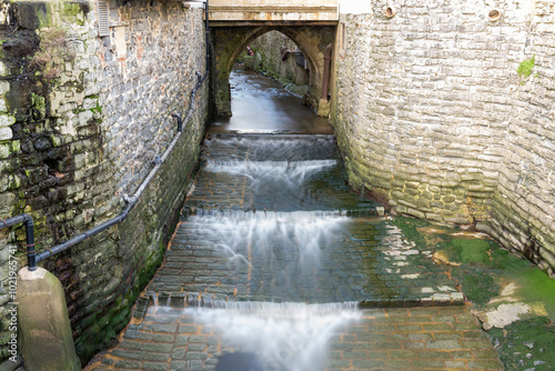 Bild auf Leinwand Long exposure of the river Lim flowing into Lyme Regis in Dorset