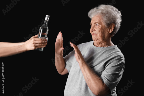 Senior woman rejecting bott...