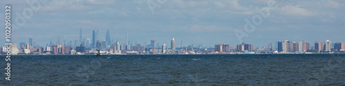 New York City is seen across the water from Sandy Hook, New Jersey. Brooklyn, including the famous Coney Island, can be seen in the front, with Manhattan Island behind.