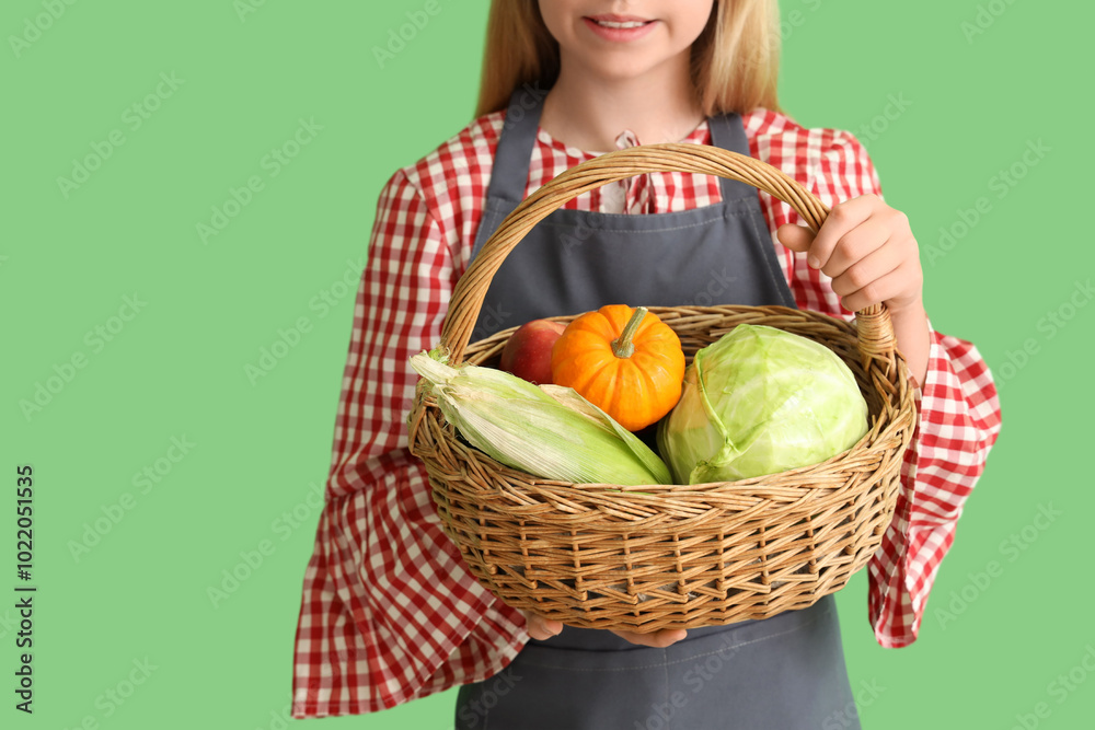 Little farmer with fresh food on green background, closeup Little farmer with fresh food on green background, closeup