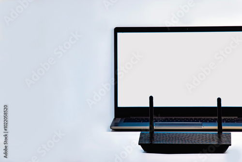 laptop and router on the white table in the ofice work or at home