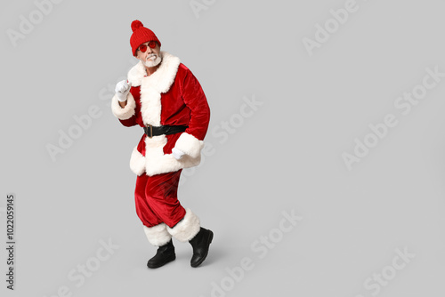 Cool Santa Claus in sunglasses on grey background