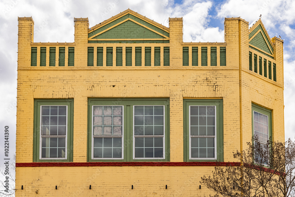 Yellow and green painted brick bulding.