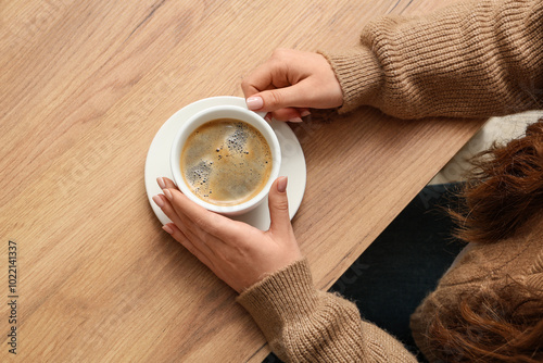 Woman holding cup of coffee...